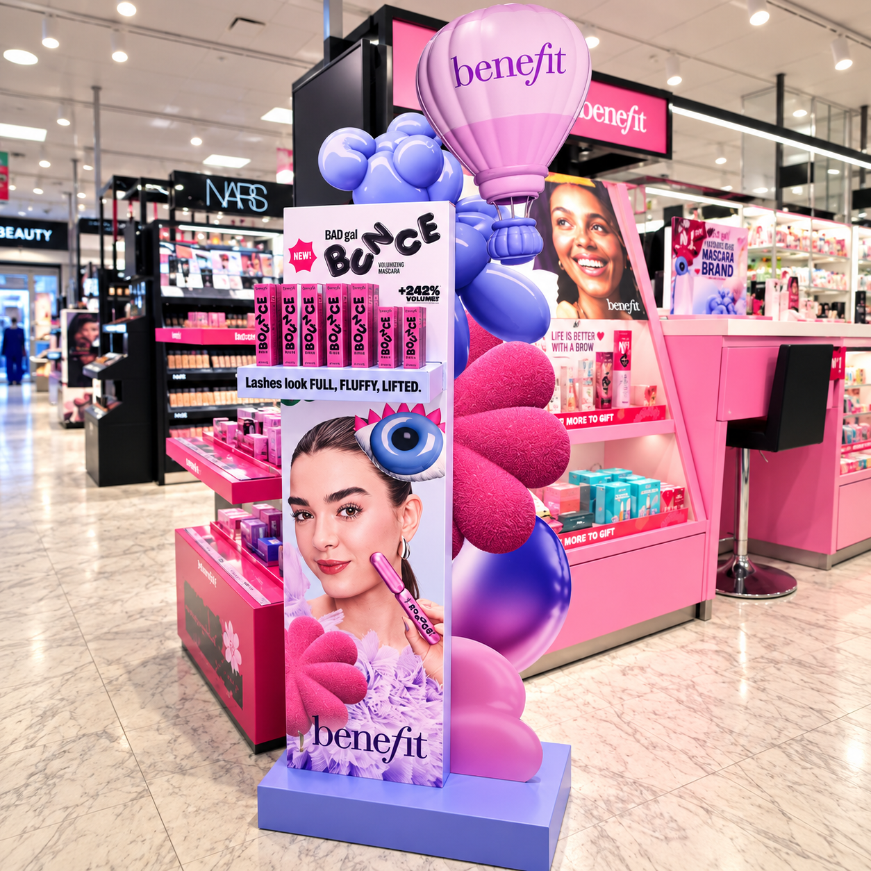 Full Benefit BADgal Bounce floor display beside the in-store beauty counter