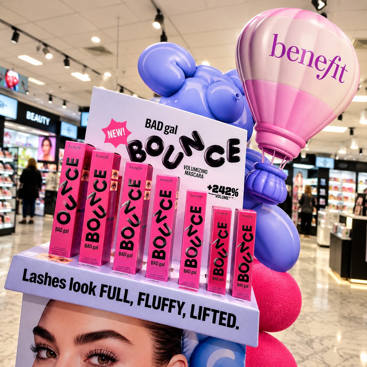 Benefit BADgal Bounce mascara boxes lined up on the FSDU shelf, balloon-dog mascot behind