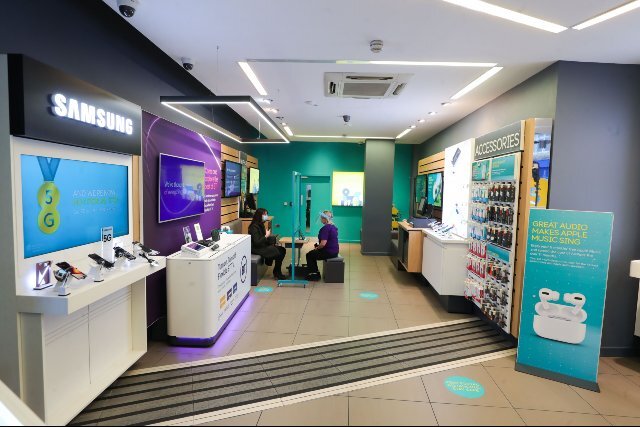 EE store interior with Samsung and Apple accessory display units
