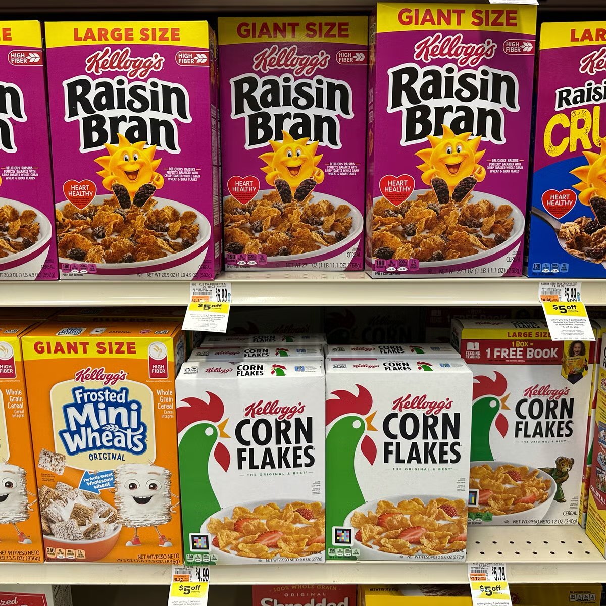 Range of Kellogg's cereal boxes including Raisin Bran, Corn Flakes and Frosted Mini-Wheats on shelf