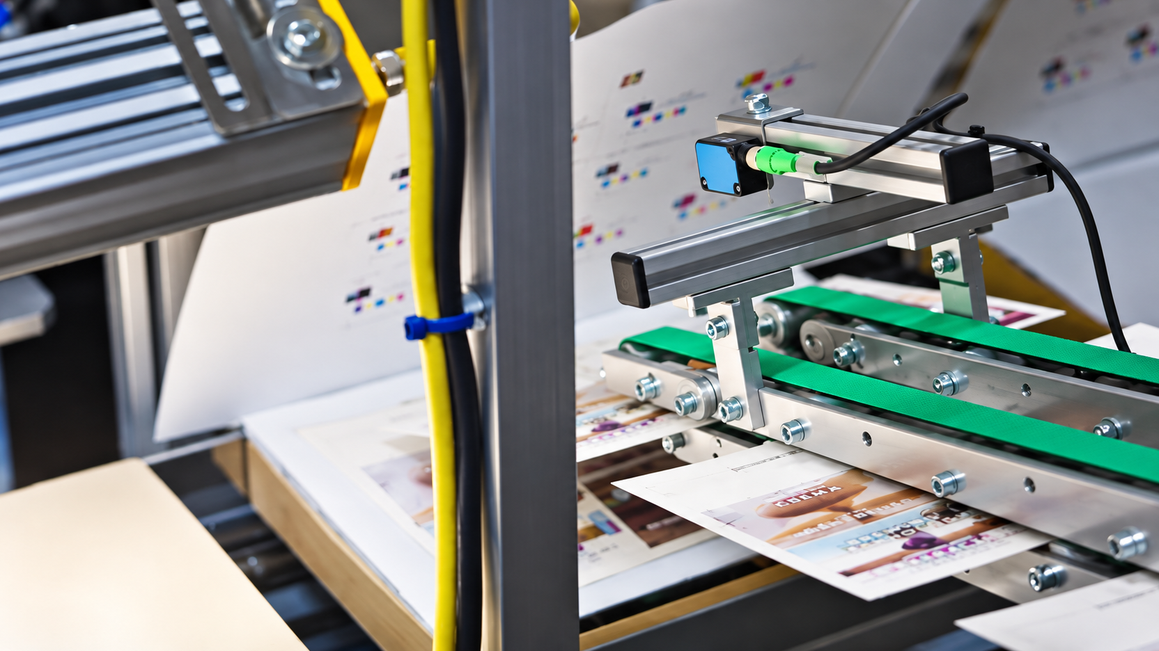 Printed cards feeding through a production line