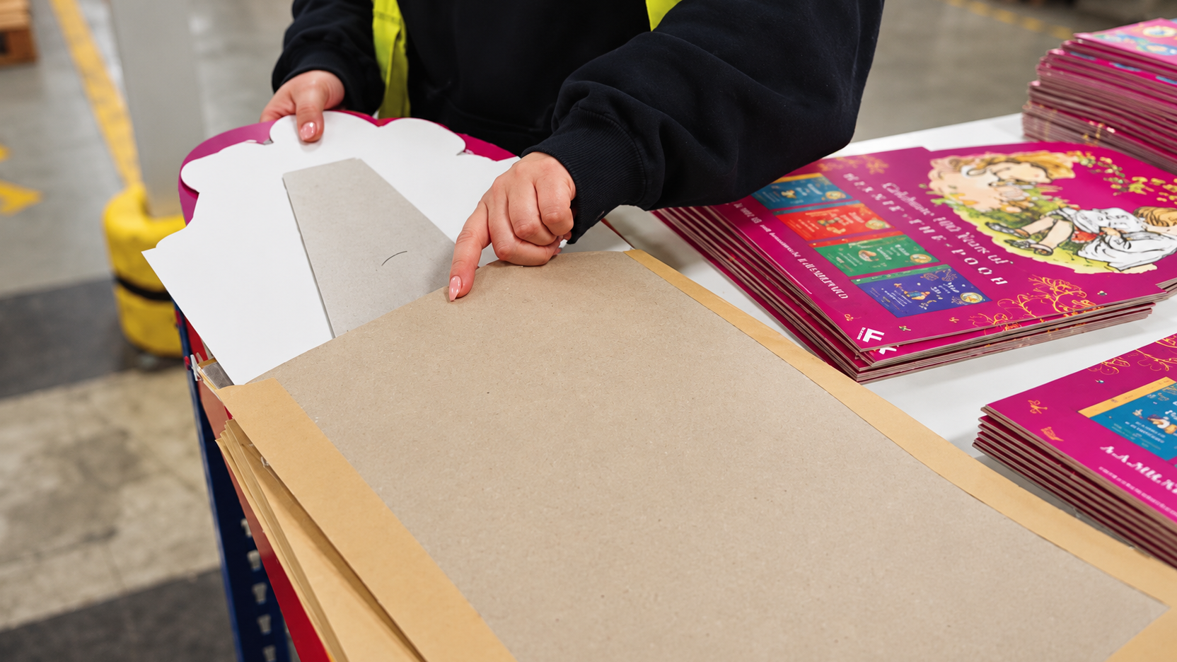 Warehouse operative handling printed display cardboard